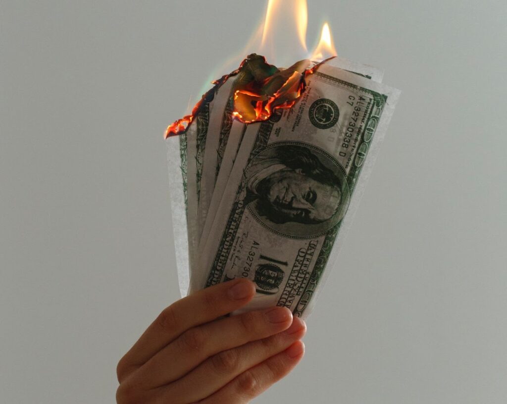 hand holding burning money