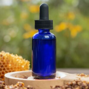 honey bee propolis tincture in a blue dropper bottle