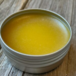 honey bee propolis salve in a tin container