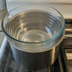 glass bowl on a simmering pot for a bee propolis recipe