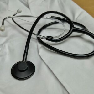 stethoscope laying on lab coat